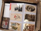 a cardboard box with a bunch of old photos in it
