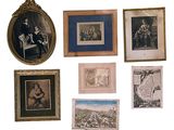 many framed pictures on the wall of this room