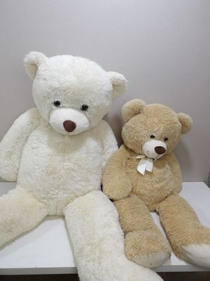 two teddy bears that are sitting on a table
