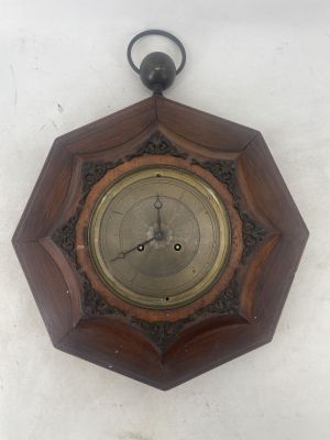a wooden clock hanging on the wall on the wall