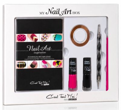 a box of nail art supplies including a nail brush and nail polish