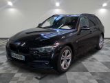 a picture of a black bmw wagon parked in a garage
