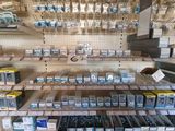 many different types of electronics on the shelves in the store