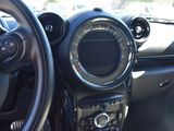 steering wheel and dashboard of a small car in a parking lot