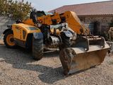 a tractor that is sitting in the gravel