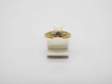 a yellow gold ring with a blue sapphire stone