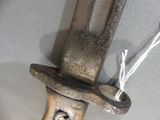 a close up of a knife with a wooden handle