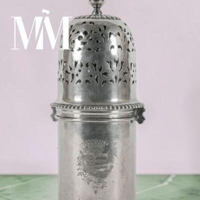 a silver cup that is sitting on a table