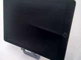 a tablet that is sitting on a stand on a table
