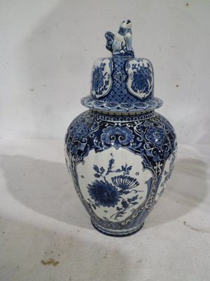 a blue and white vase with a bird on it