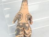 a small figurine of a man standing in front of a clear box