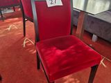red chairs and a table in a room with a red carpet