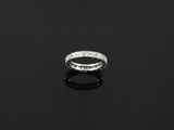 a diamond eternity ring on a black surface