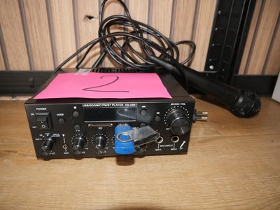 a microphone sitting on a table next to a radio