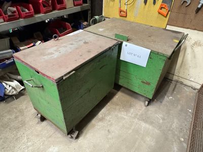 two green boxes sitting next to each other in a garage