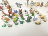 a lot of figurines that are sitting on a table