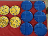 a red table with blue plates and yellow plates on it