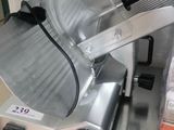 a meat slicer sitting on a counter in a kitchen