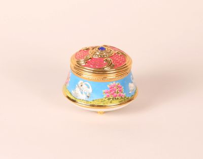 an image of a small blue and gold box on a white surface