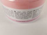 a close up of a pink container with a label on it