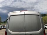a silver van that is parked in a parking lot