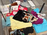 a glass table with a lot of clothing on it