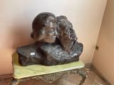 a statue of a man and a woman sitting on a bench
