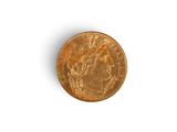 a close up of a gold coin on a white surface