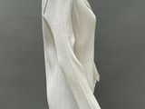 a mannequin wearing a white sweater and black pants