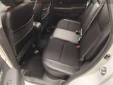 the back seats of a white car with black leather trims