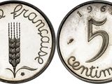 a close up of a coin with the number five on it