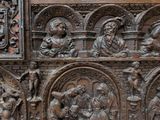 an old wooden chest with carvings of people and animals on it