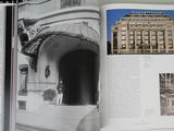 an open book with a picture of a building in the background