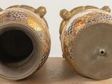 two vases that are sitting on a table