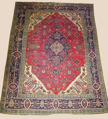 a red and blue rug with a medallion design on it