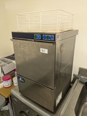a silver dishwasher sitting on top of a kitchen counter