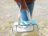 a man carrying a white bag in a parking lot
