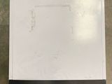a piece of white paper on the floor next to a piece of black paper