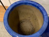 a blue vase sitting on a pallet next to a wall