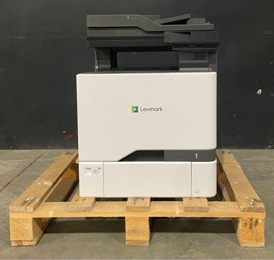 a white printer sitting on top of a wooden pallet