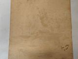 an old piece of paper with writing on it sitting on top of a table