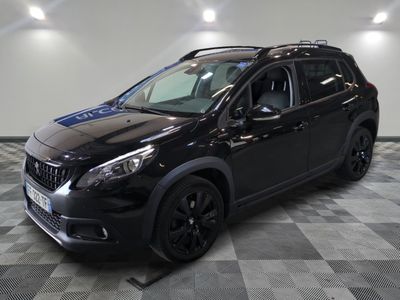 the black car is parked in the garage on the checkered floor