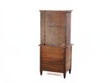 an old wooden cabinet with a drawer on top of it