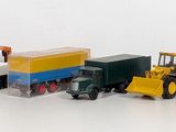many toy trucks that are lined up on a white surface