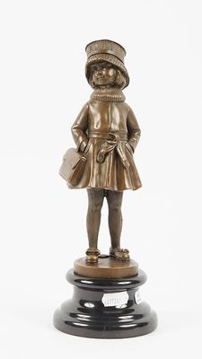 bronze figurine of a girl with a hat and a bag