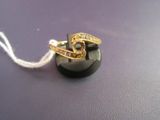 a black button with a gold ring on top of it