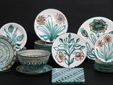 many plates and bowls that are sitting on a table