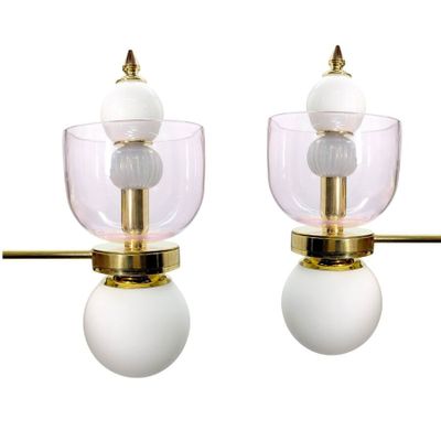 pair of brass and glass table lamps with white globe shades