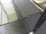 a glass table with an umbrella on top of it