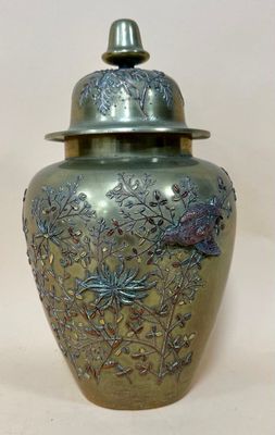 a silver vase with a lid on a white background